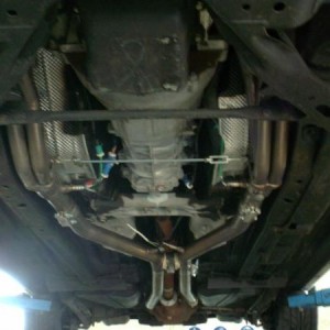 shot of the full exhaust and view of the header adjustment point to keep the collectors from rattling on the frame rails
